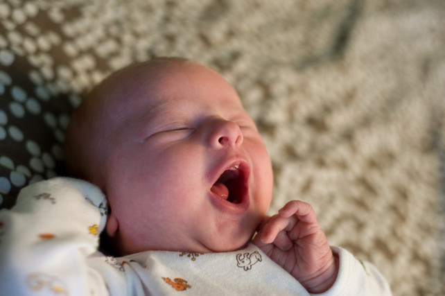 Newborn baby girl yawning