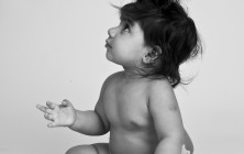 Black and white studio portrait of an Asian baby girl in a nappy.