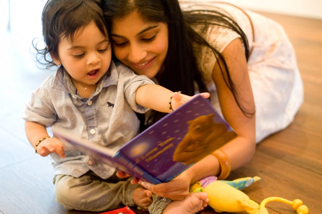 Mother reading book with son