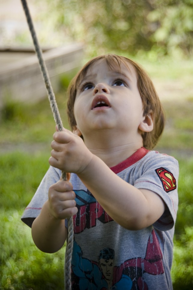 Young boy pulling a rope
